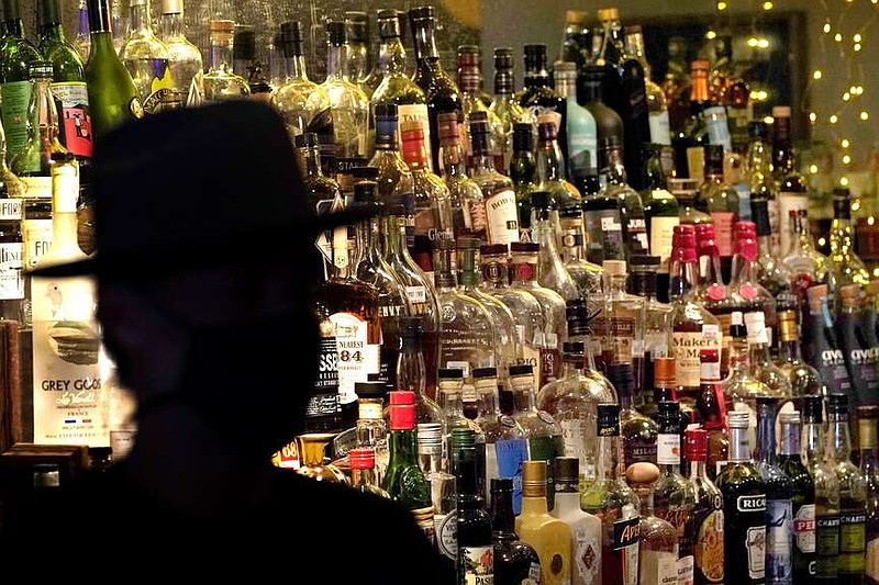 Bottles of alcohol sit on shelves at a bar June 23, 2020, in Houston. (AP Photo/David J. Phillip, File)