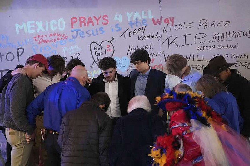 Friends of Kareem Badawi, a victim of the deadly truck attack on New Year's Day in New Orleans, pray at a memorial for victims after attending his funeral, Friday, Jan. 3, 2025. (AP Photo/Gerald Herbert)