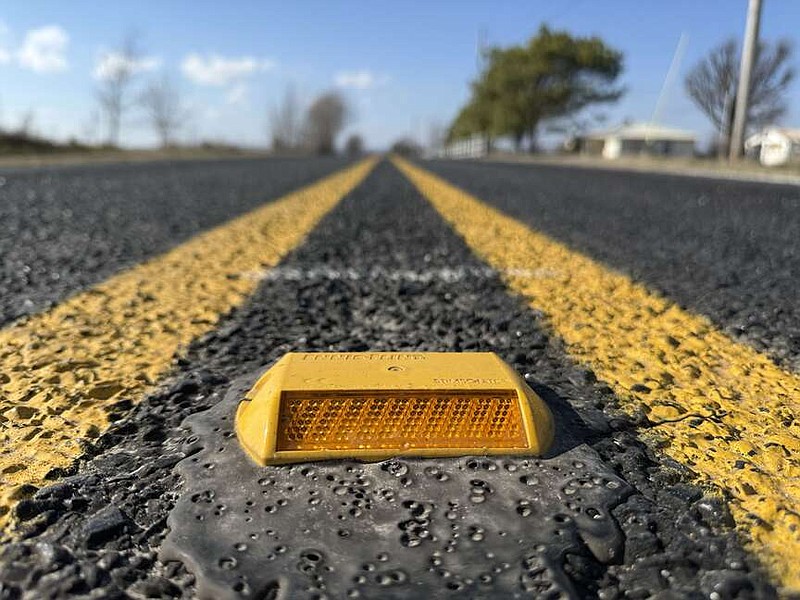 An amber pavement marker is affixed Monday, Dec. 30, 2024, to the center of Rheas Mill Road west of Little Elm Road in Farmington. The Washington County Road Department made improvements to the busy road in 2024. Visit nwaonline.com/photo for today's photo gallery.
(NWA Democrat-Gazette/Andy Shupe)