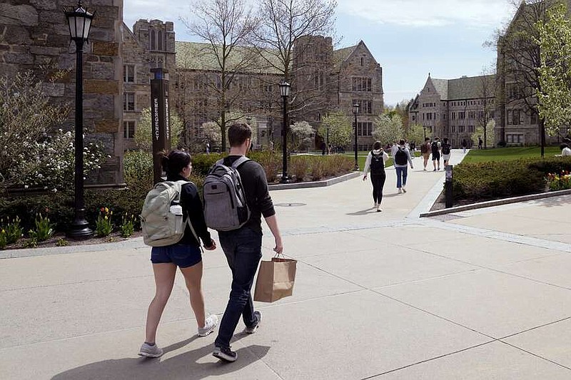 Students walk on the campus of Boston College on April 29, 2024, in Boston. (AP Photo/Charles Krupa, File)