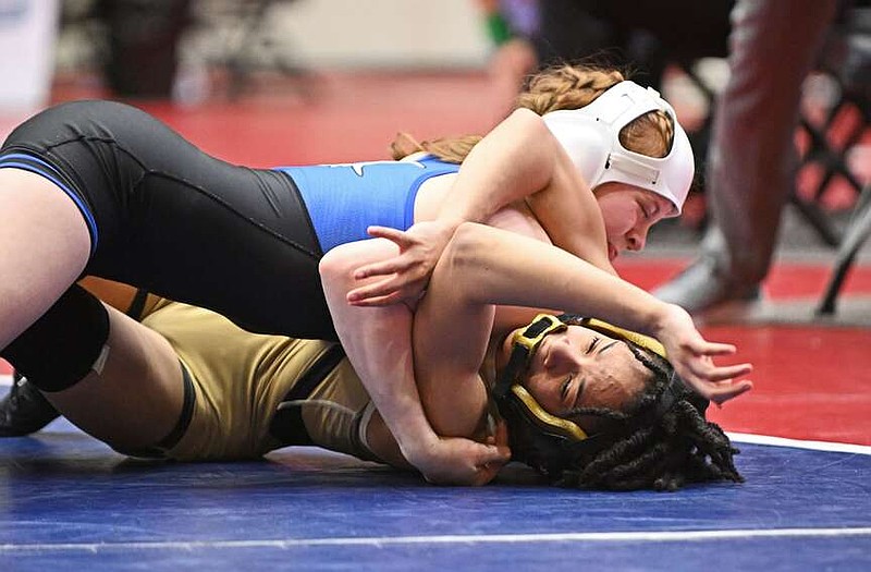 Rogers' Dalani Hornbuckle (blue) and Little Rock Central's Laila Jordan wrestle for first place in the girls' 6A 105 weight class of the State High School Wrestling Championships on Saturday at the Jack Stephens Center in Little Rock. See more photos at arkansasonline.com/225gwrestle/
(Arkansas Democrat-Gazette/Staci Vandagriff)