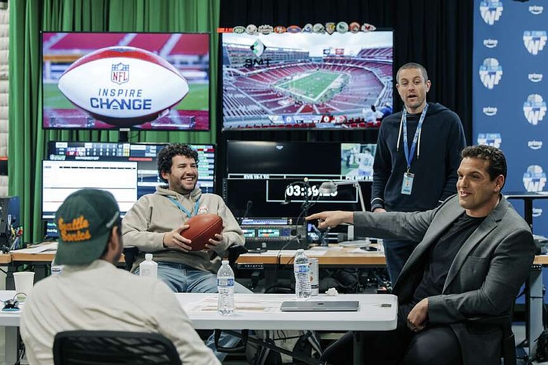 IN this image provided by Amazon Prime Video, from left, Prime Video Senior Coordinating Producer Alex Strand; Keegan Abdoo of the NFL's Next Gen Stats Department; Scott Karpen, Producer of “Prime Vision with Next Gen Stats”; and Prime Video “Thursday Night Football” analytics expert Sam Schwartzstein talk at the Amazon/MGM Studios in Culver City, Calif., Thursday, Dec 12, 2024, , before the Los Angeles Rams-San Francisco 49ers NFL football game. (Timothy Buckman/Amazon Prime Video via AP)