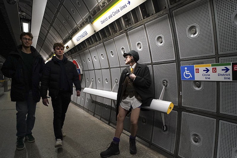 A man sits by the platform of an underground station, during the annual event &quot;No Trousers Tube Ride&quot; in London, Sunday, Jan. 12, 2025. (AP Photo/Alberto Pezzali)