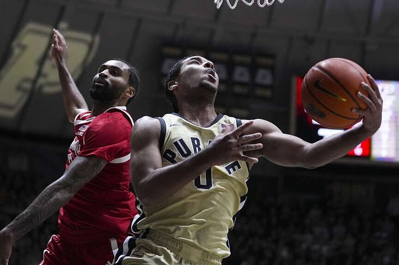 Purdue guard C.J. Cox (0) shoots around Nebraska guard Brice Williams (3) in the second half of an NCAA college basketball game in West Lafayette, Ind., Sunday, Jan. 12, 2025. (AP Photo/Michael Conroy)