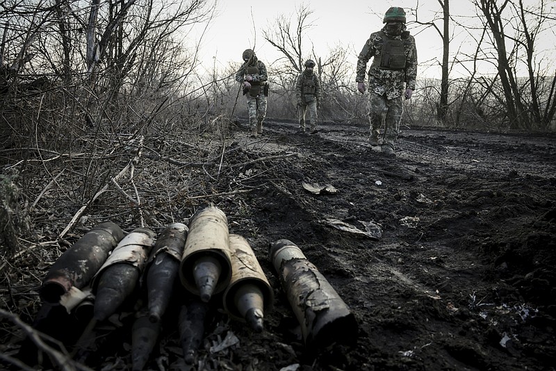 Ukrainian servicemen collect damaged ammunition on the road at the front line near Chasiv Yar town, in Donetsk region, Ukraine, Ukraine, Friday, Jan. 10, 2025. (Oleg Petrasiuk/Ukraine's 24th Mechanised Brigade via AP)