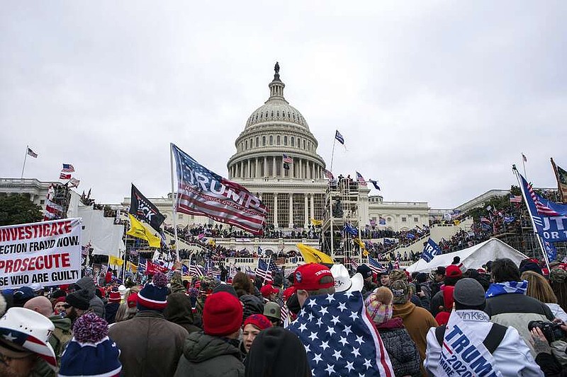 Supporters of President Donald Trump rally at the U.S. Capitol on Jan. 6, 2021, in Washington. As a winter storm bore down on the nation's capital four years later, lawmakers would again gather at the U.S. Capitol, this time without protests, challenges or violence — but behind layers of black security fencing serving — to certify Trump's 2024 win over Vice President Kamala Harris. (AP Photo/Jose Luis Magana)