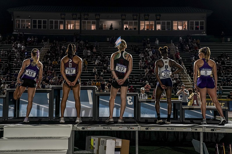 A transgender sprinter wears a trans flag in her hair at the 2024 NCAA Division III outdoor track and field championships at Doug Shaw Memorial Stadium in Myrtle Beach, South Carolina. MUST CREDIT: Jahi Chikwendiu/The Washington Post