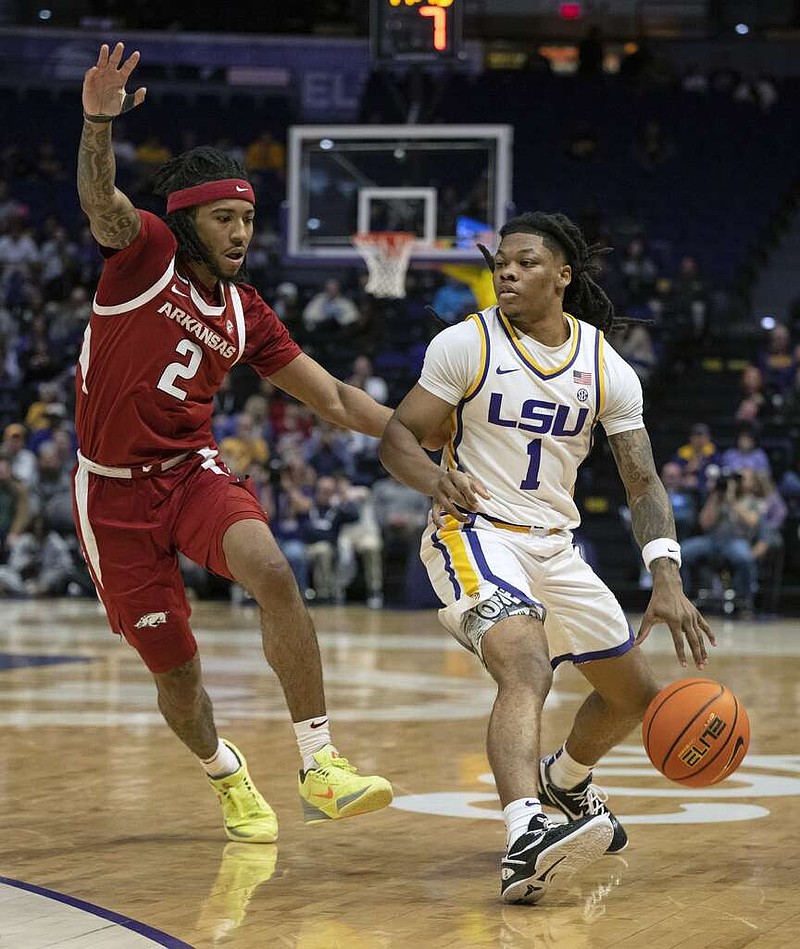 LSU guard Jordan Sears (1) drives against Arkansas guard Boogie Fland (2) in Tuesday night's game at the LSU PMAC in Baton Rouge, La. (Hilary Scheinuk/The Advocate via AP)