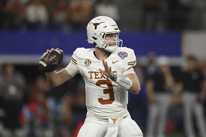 Texas quarterback Quinn Ewers (3) passes against Ohio State during the first half of the Cotton Bowl College Football Playoff semifinal game on Friday in Arlington, Texas. (AP Photo/Gareth Patterson)