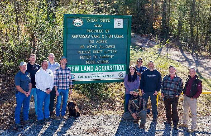 Representatives from the Arkansas Game and Fish Commission and the Arkansas Chapter of Backcountry Hunters and Anglers gather to dedicate the land acquisition of a 0.9-acre parcel that will maintain public access to Cedar Creek WMA near Waldron. (Courtesy of AGFC)