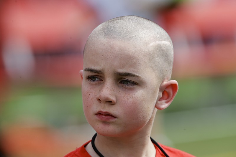 FILE - Cancer survivor Jack Hoffman before delivering a drug-free pledge during the halftime of Nebraska's NCAA college football spring game in Lincoln, Neb., April 12, 2014. (AP Photo/Nati Harnik, File)