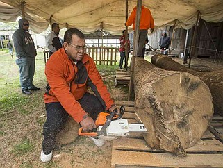 NWA Democrat-Gazette/BEN GOFF @NWABENGOFF
Liton Beasa, master canoe builder, begins shaping a log Saturday, April 14, 2018, during a ceremony to launch a project to build a Marshallese KorKor, a type of outrigger canoe, at the Shiloh Museum of Ozark History in Springdale. Over the coming weeks Beasa, born and raised on Namdrik Atoll in the Marshall Islands and living in Springdale since 2013, and his family will build a roughly 20 foot long KorKor at the museum with opportunities for school groups and the public to observe. On the Marshall Islands canoes are built from breadfruit trees, but this canoe will be built from a locally-sourced sycamore tree. The builders plan to feature the finished canoe during Jemenei Day (Marshallese constitution day) celebrations in Springdale between May 25-28. The project is supported by the Arkansas Coalition of Marshallese of Springdale and the Shiloh Museum of Ozark History, with grants from the Arkansas Humanities Council and the National Endowment for the Humanities.