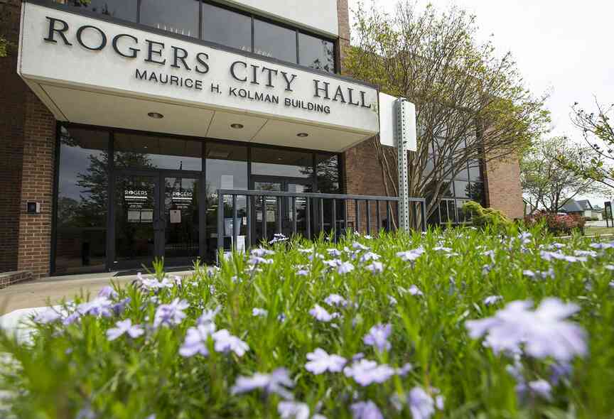 Flowers bloom May 1, 2020, at the entrance to Rogers City Hall.
(File Photo/NWA Democrat-Gazette)