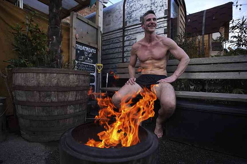 David Saville sits during his sauna meeting at the Hackney Wick Community Sauna Baths on February 25, 2025 in London at a Camp Fire. (AP Photo/Kin Cheung)