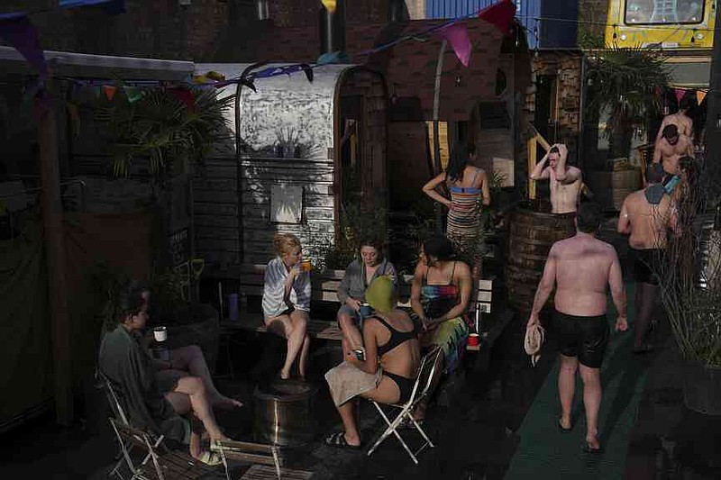 Visitors enjoy their sauna meeting on February 25, 2025 in London in the Hackney Wick Community Sauna Bads. (AP Photo/Kin Cheung)