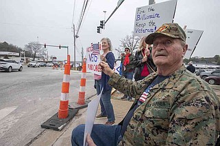 Dennis Estes of Fayetteville waves a flag Saturday March 15, 2025 during the Save Your VA rally at the Veterans Health Care System of the Ozarks in Fayetteville. Estes served in Vietnam in the Marines. Around five hundred people turned out to oppose the announced plan to fire 83,000 employees at the VA. Visit nwaonline.com/photo for today's photo gallery. (NWA Democrat-Gazette/J.T. Wampler)