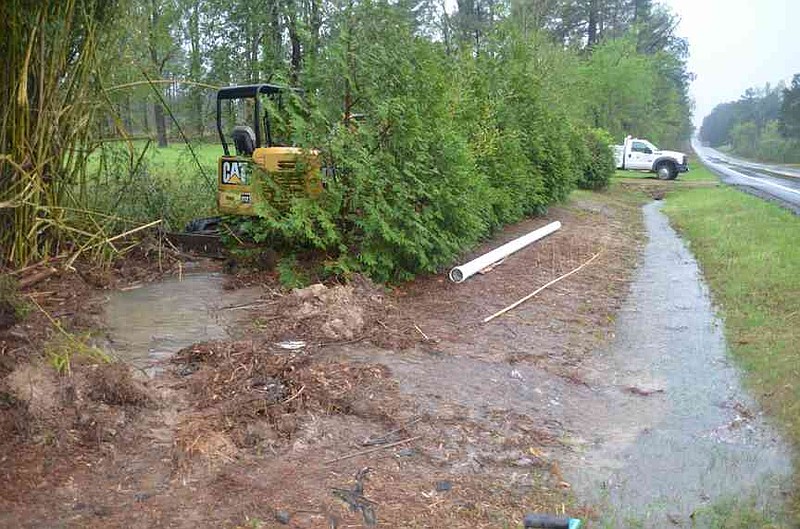 A direct lightning strike to a massive pine tree, located adjacent to a rural water main, blew a large hole in the system causing customers to lose water pressure overnight on Highway 273, two miles west of Fordyce. (Special to The Commercial/Richard Ledbetter)