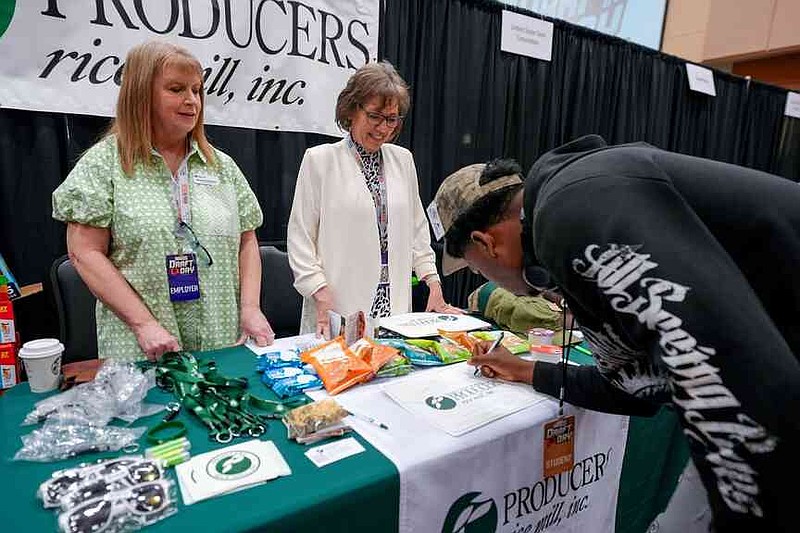 A high school student fills out information at the Producers Rice Mill table Thursday, April 1, 2025. (Special to The Commercial)