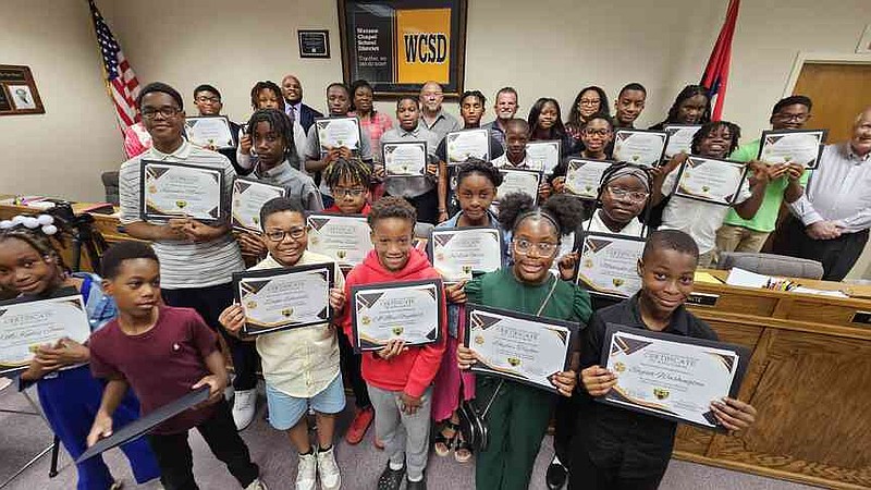 Many Watson Chapel School District students show off their certificates of achievement for growth on interim ATLAS tests. (Pine Bluff Commercial/I.C. Murrell)