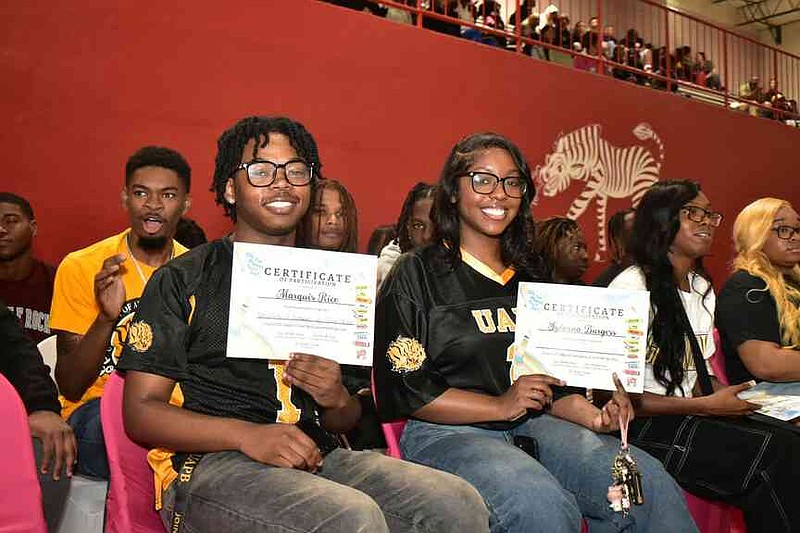 Pine Bluff High School seniors Marquis Rice and Sylvana Burgess hold up their certificates of participation at the College and Career Signing Day. (Pine Bluff Commercial/I.C. Murrell)