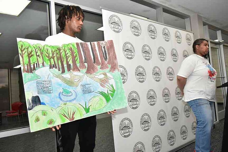 Jabralyn Bankston and Ginger Broadway, both juniors at Pine Bluff High School, present their drawing of Canary Island pine trees during a presentation inside the Det. Kevin D. Collins Center at the Pine Bluff Civic Center on Friday, April 25, 2025. (Pine Bluff Commercial/I.C. Murrell)
