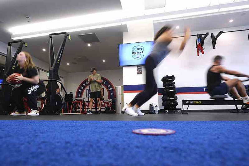 Members of the public at the South By Southwest conference festival go through the paces of two-time IndyCar series champion Josef Newgarden's physical workout, a cross-fit session designed to fine-tune the entire body for strength and endurance in racing, Thursday, March 13, 2025, in Austin, Texas. (AP Photo/Eric Gay)