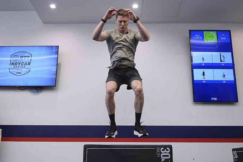 Two-time IndyCar series champion Josef Newgarden leads a group through the paces of his physical workout, a cross-fit session designed to fine-tune the entire body for strength and endurance in racing, Thursday, March 13, 2025, in Austin, Texas. (AP Photo/Eric Gay)