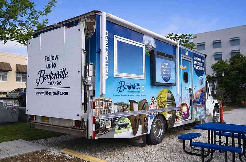 The Visit Bentonville mobile information center is parked Thursday at the 200 block of Second Street near the downtown square in Bentonville. The center is designed to offer visitors and locals information about local attractions, arts, events and outdoor experiences, according to a news release. Visit nwaonline.com/photo for today's photo gallery. (NWA Democrat-Gazette/Charlie Kaijo)