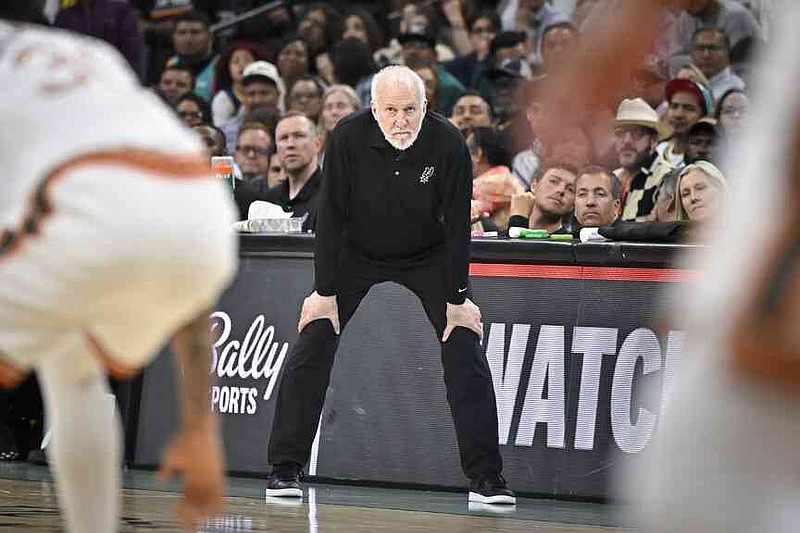 File -San Antonio Spurs trainer Gregg Popovich watches the team against the Golden State Warriors in San Antonio in the team of the team's NBA basketball game against the Golden State Warriors. (AP Photo/Darren Abate, File)