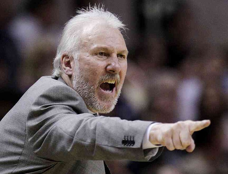 File -San Antonio Spurs trainer Gregg Popovich heads his team in the fourth quarter of an NBA basketball game against the New Orleans Hornets in San Antonio on Wednesday, April 15, 2009. (AP Photo/Eric Gay, File)