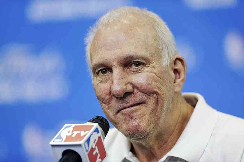 File - In this June 14, 2014, the head coach of San Antonio Spurs Gregg Popovich smiles that a question is asked during a press conference for the NBA basketball final in San Antonio. (AP Photo/Tony Gutierrez, File)