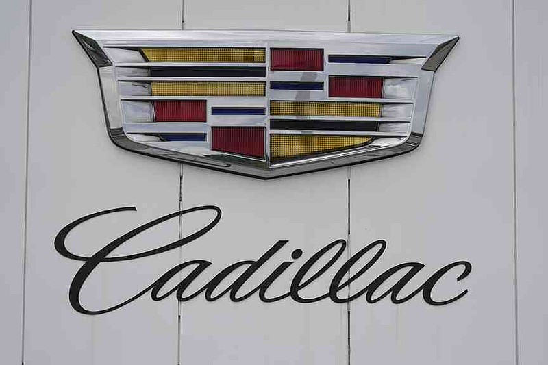 FILE - The company crest and logo hang over the doors to the showroom of a Cadillac dealership, June 2, 2024, in Lone Tree, Colo. (AP Photo/David Zalubowski, file)