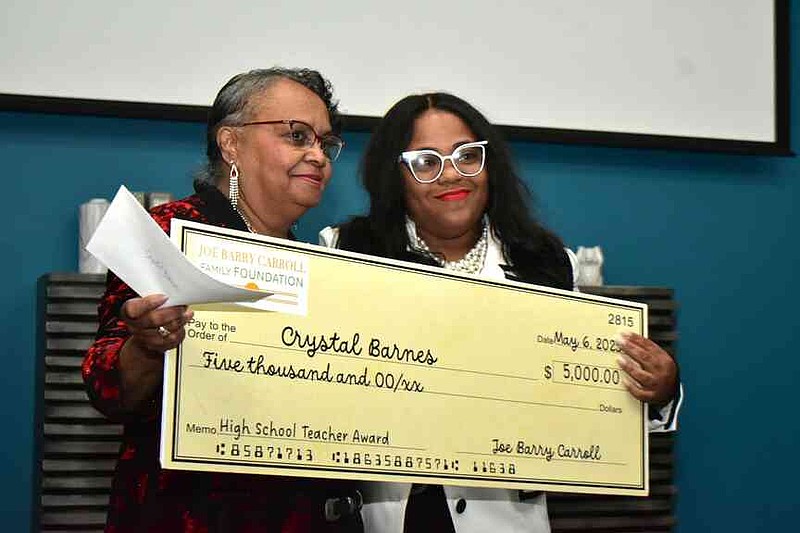 Mary Carroll poses with Joe Barry Carroll Award winner Crystal Barnes of Pine Bluff High School and a $5,000 check. (Pine Bluff Commercial/I.C. Murrell)
