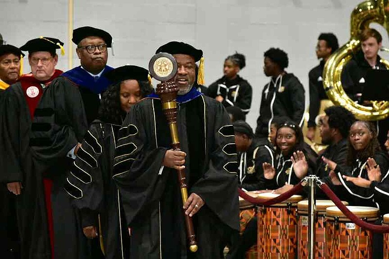 Charles Colen, chairman of the Department of Industrial Technology Management & Applied Engineering at the University of Arkansas at Pine Bluff, leads the processional into the Pine Bluff Convention Center with the school mace signaling the start of graduation ceremonies in this Dec. 14, 2024, file photo. Spring graduation is today at the Convention Center, starting with the processional at 9:45 a.m. (Pine Bluff Commercial/I.C. Murrell)