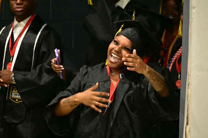 Damaria Hudson dances in joy during the processional. (Pine Bluff Commercial/I.C. Murrell)
