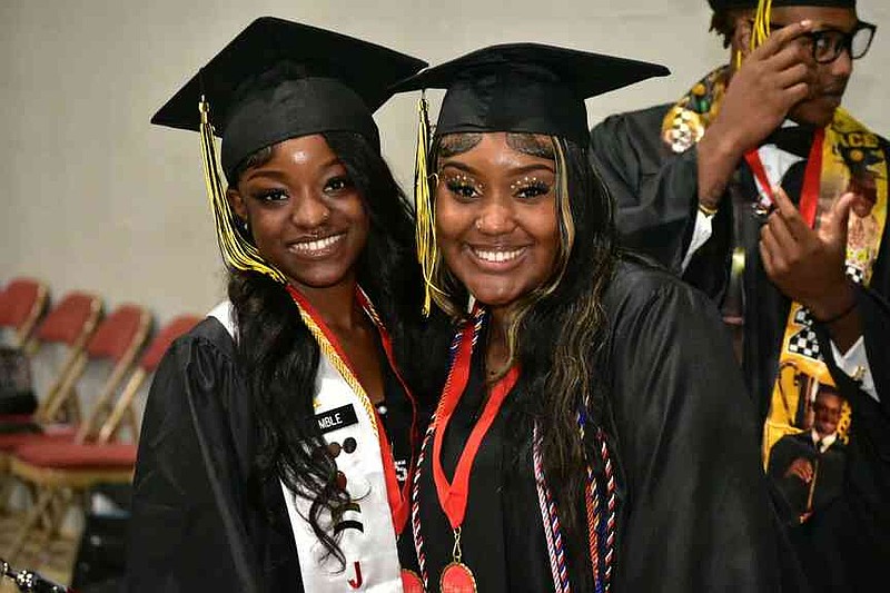 Friends Makayla Kimble and Kenya Ruth pose as they arrive on the arena floor. (Pine Bluff Commercial/I.C. Murrell)