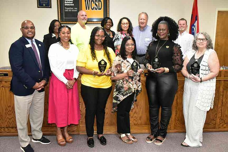 The Watson Chapel School District's teachers of the year for the 2024-25 school year are honored. Front row from left: Superintendent Keith McGee, assistant superintendent Aleta Posey, Takela Moreland of Edgewood Elementary, Mary Johnson of Coleman Elementary, Sherita Thomas of Watson Chapel Junior High School and Deborah Williams of Watson Chapel High School. Back row: WCSD board members Goldie Whitaker, Kevin Moore, Connie Compton, Rosemary White, Alan Frazier and Donnie Hartsfield. (Pine Bluff Commercial/I.C. Murrell)
