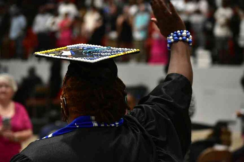 Lakisha Johnson waves to supports as she enters the Convention Center arena. (Pine Bluff Commercial/I.C. Murrell)