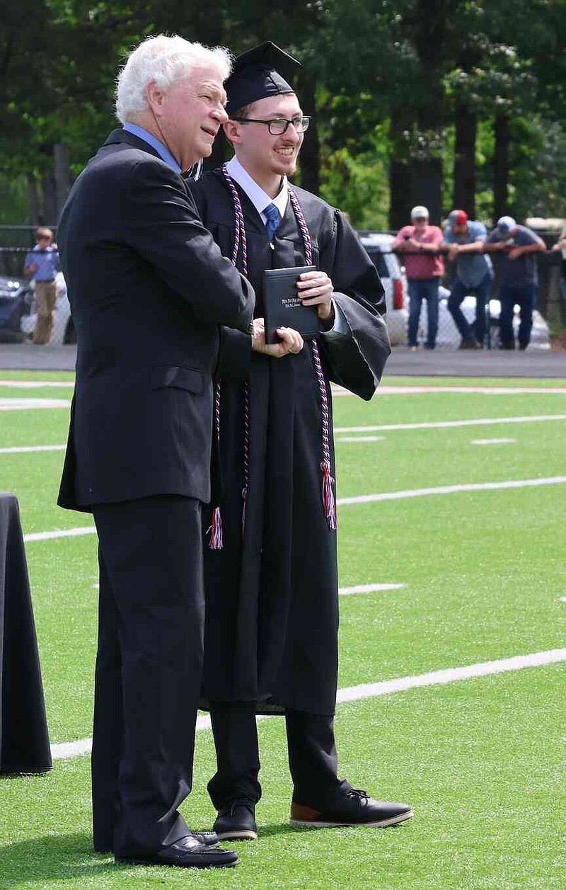 White Hall School District President Dr. Raymond Jones presents a diploma to Richard Pye. (Special to The Commercial/Deborah Horn)