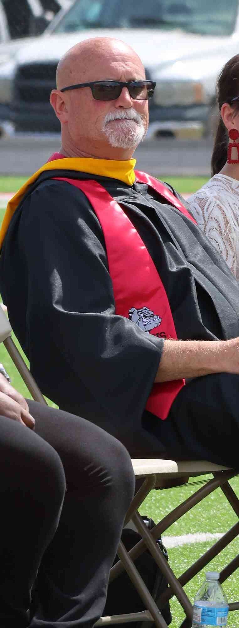 White Hall High School Principal Nathan Sullivan listens to graduation speeches. (Special to The Commercial/Deborah Horn)