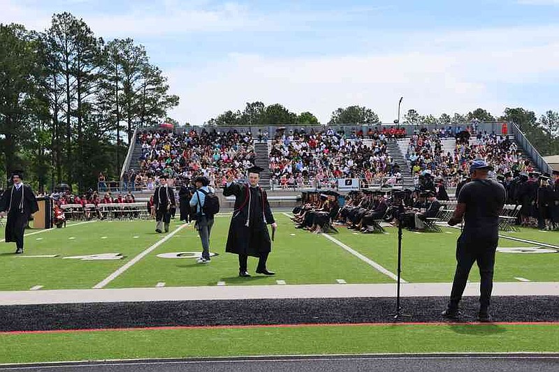 A large crowd saw more than 200 White Hall High School students graduate at Bulldog Stadium on Saturday morning, less than a day after inclement weather postponed commencement. (Special to The Commercial/Deborah Horn)