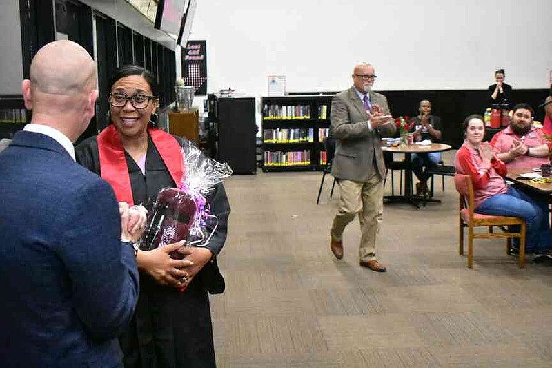 State Education Secretary Jacob Oliva congratulates White Hall High secretary Leslie Mitchell on her graduation from the University of Arkansas, Fayetteville. (Pine Bluff Commercial/I.C. Murrell)