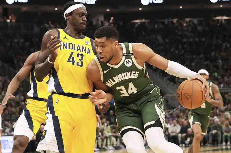 Milwaukee Buck's striker Giannis Antetocounmpo, right, drives in game 3 of an NBA basketball playoff series on Friday, April 25, 2025, in Milwaukee against the striker of Indiana Pacers Pacers Siakam (43). (AP Photo/Nam Y. Huh)