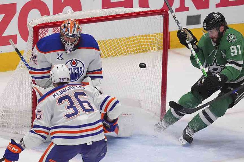 The goalkeeper of Edmonton Oilers Stuart Skinner (74) and defender John Klingberg (36) defend the goal against the Dallas Stars Center Tyler Seguin (91) in the third period in the first game 1 of the Western Conference Final in the NHL -Hockey Stanley Cup Playoffs on Wednesday, May 21, 2025 in Dallas. (AP Photo/LM Otero)
