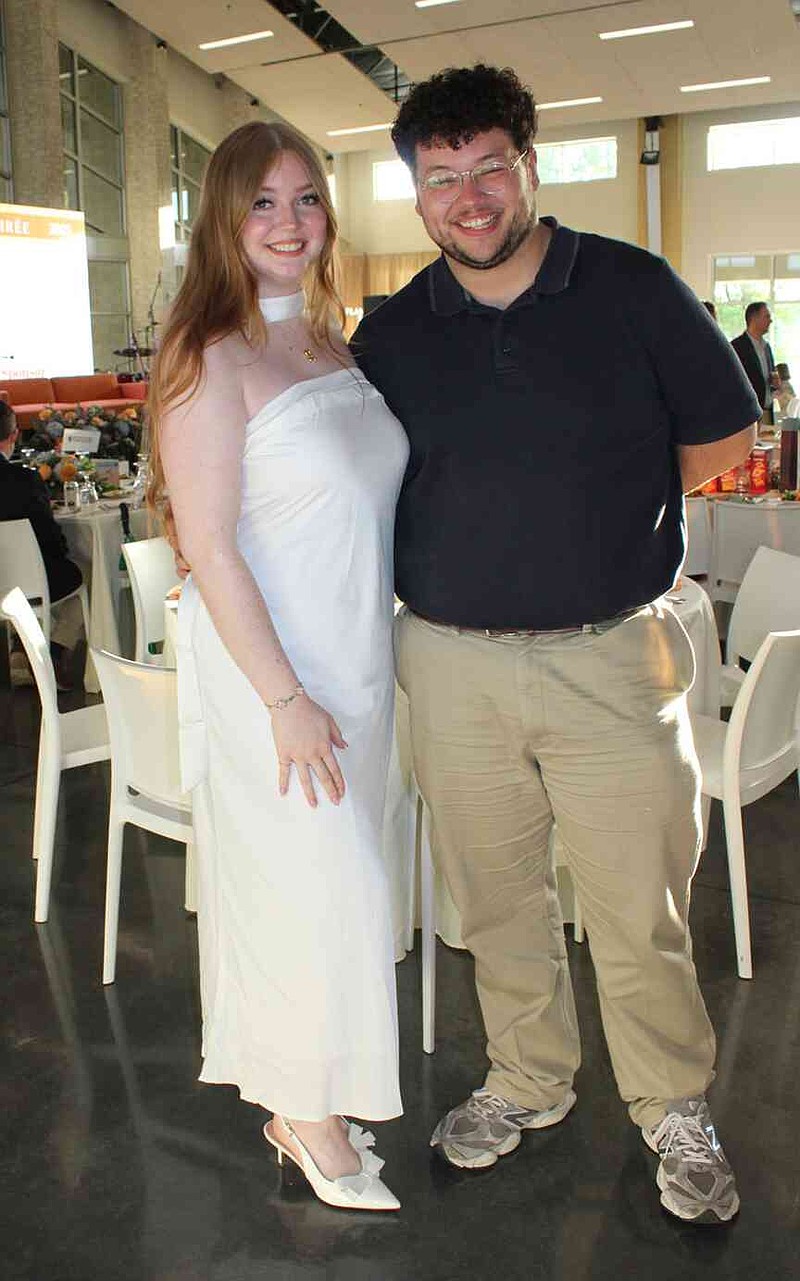 Rachel Sharp y Reuben Nino toman fotos del mar de semillas de plantas. (NWA Democrat Worship/Karin Shopmeyer)
