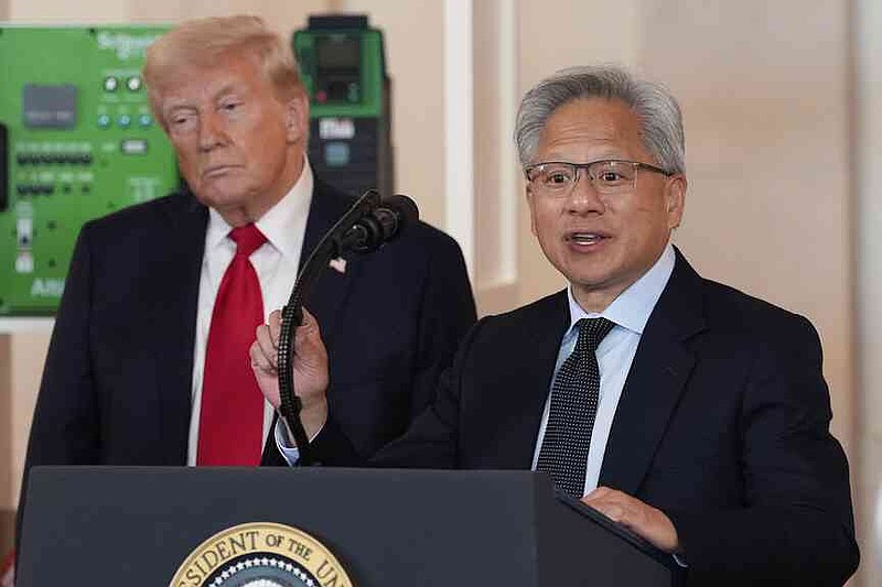 President Donald Trump listens to how Nvidia CEO Jensen Huang speaks in Washington during an event about investments in America in the Cross Hall of the White House on Wednesday, April 30, 2025. (AP Photo/Alex Brandon)