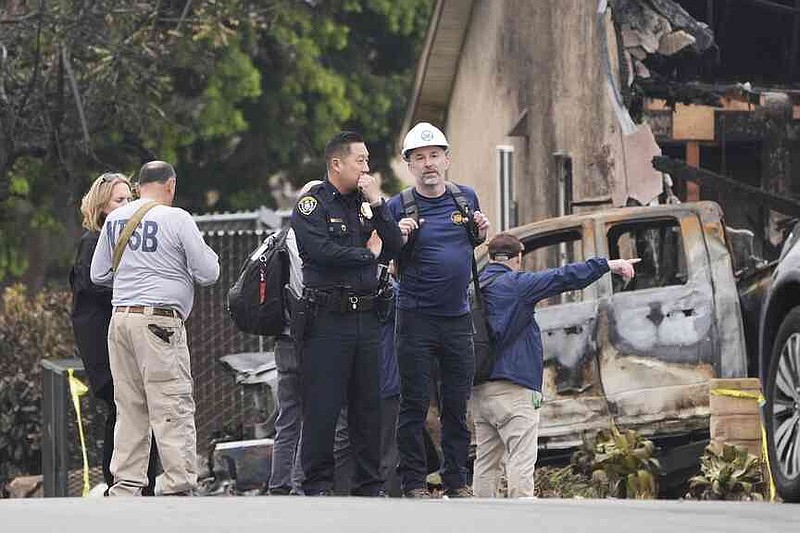 The investigators work at the location of a plane crash on Friday, May 23, 2025, in San Diego. (AP Photo/Gregory Bull)