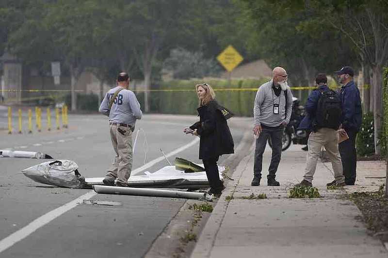 The investigators work at the location of a plane crash on Friday, May 23, 2025, in San Diego. (AP Photo/Gregory Bull)