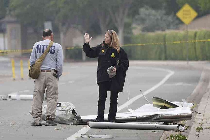 The investigators work at the location of a plane crash on Friday, May 23, 2025, in San Diego. (AP Photo/Gregory Bull)