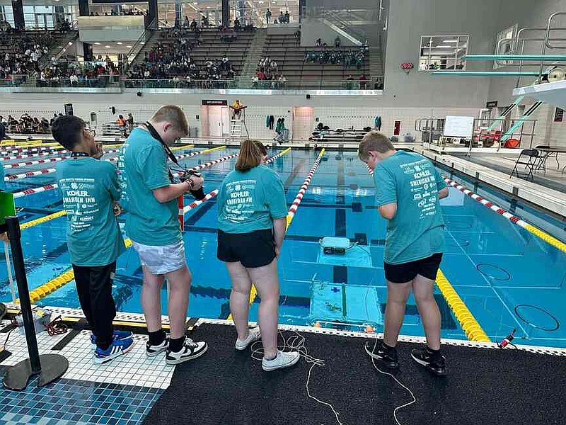 Priyesh Laxmi, Cooper Henderson, Abigail Martin and Jackson Knight work together to navigate their first-place winning remotely operated vehicle through an underwater obstacle course at the International SeaPerch Challenge. (Special to The Commercial/University of Arkansas System Division of Agriculture)